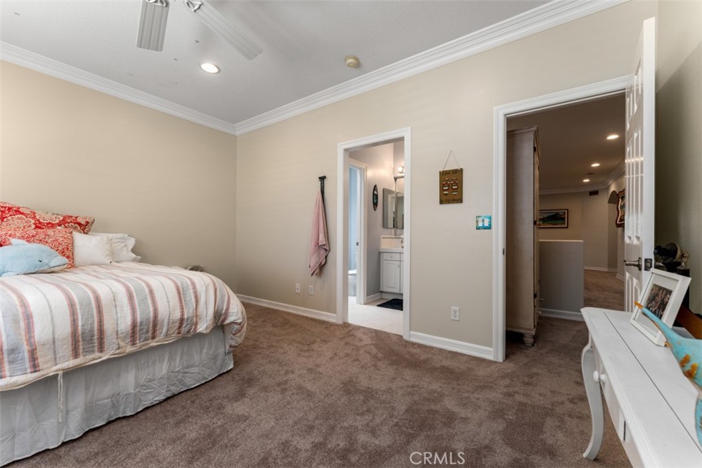 124 Nighthawk Irvine, CA 92604 - Photo 32 of 61 a spacious bedroom with a bed and a couch