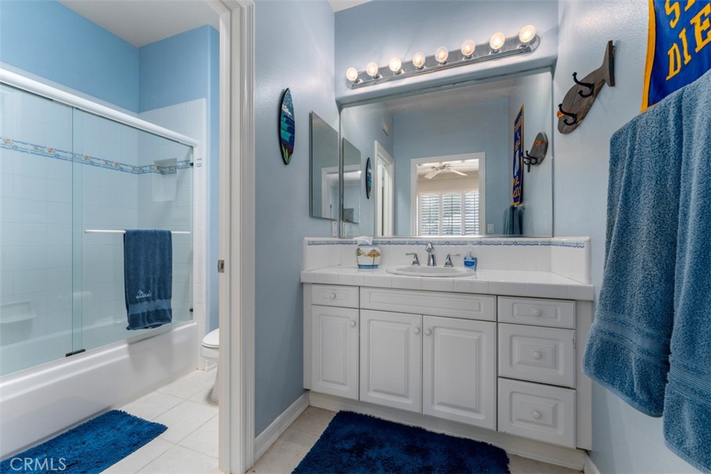 124 Nighthawk Irvine, CA 92604 - Photo 33 of 61 a bathroom with a double vanity sink a large mirror a bathtub and shower