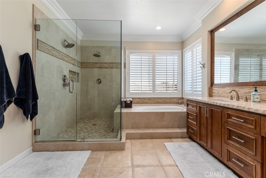 124 Nighthawk Irvine, CA 92604 - Photo 43 of 61 a spacious bathroom with a granite countertop tub shower and sink