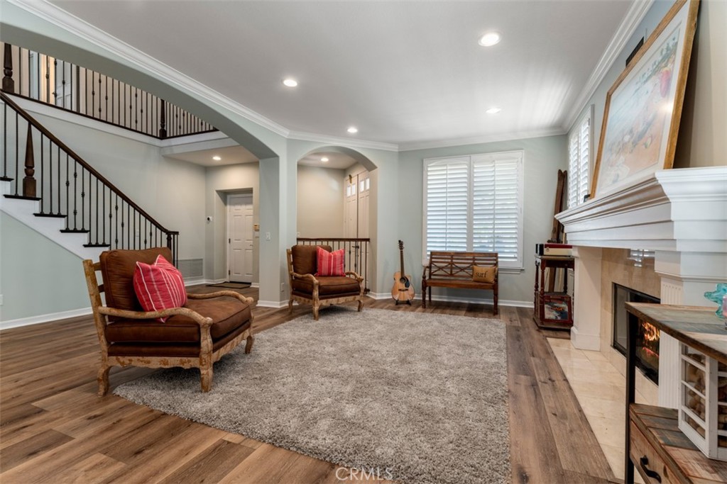 124 Nighthawk Irvine, CA 92604 - Photo 5 of 61 a living room with furniture a fireplace and a chandelier