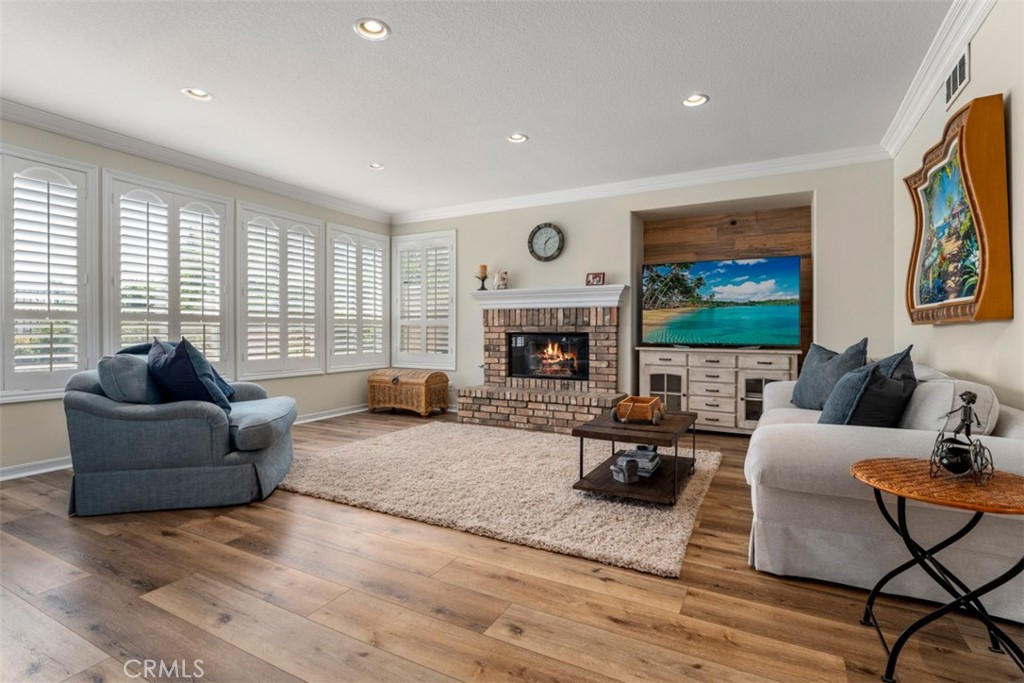 124 Nighthawk Irvine, CA 92604 - Photo 8 of 61 a living room with fireplace furniture and a flat screen tv