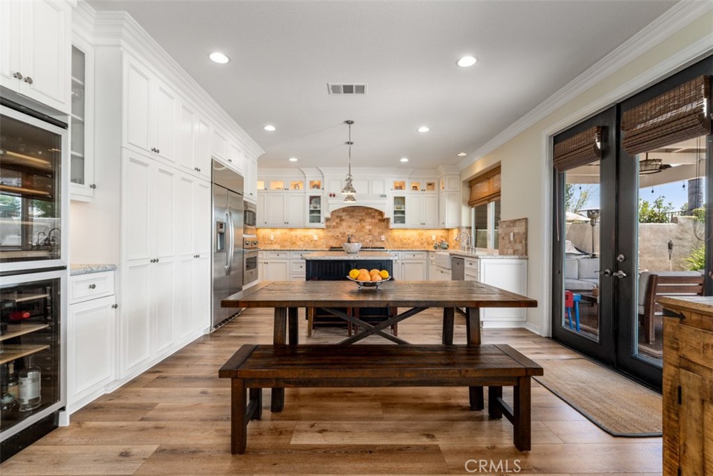 124 Nighthawk Irvine, CA 92604 - Photo 10 of 61 a view of a kitchen with kitchen island dining table and wooden floor