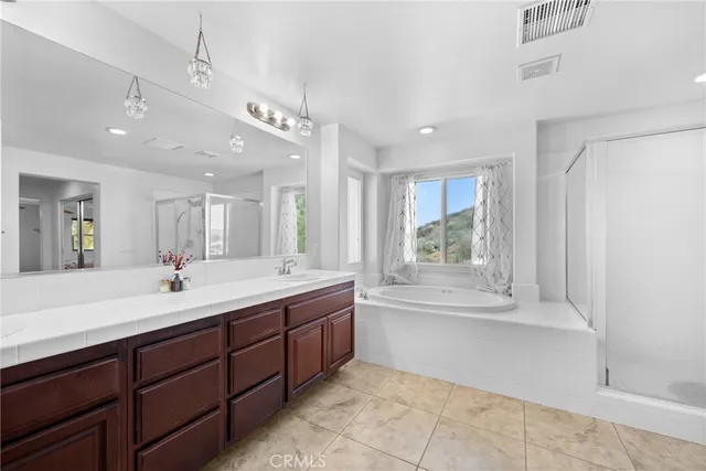 a bedroom with a bed and a ceiling fan