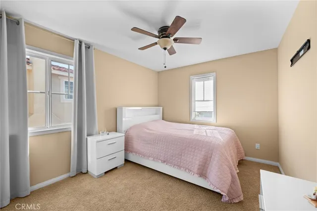 a living room with furniture and a ceiling fan
