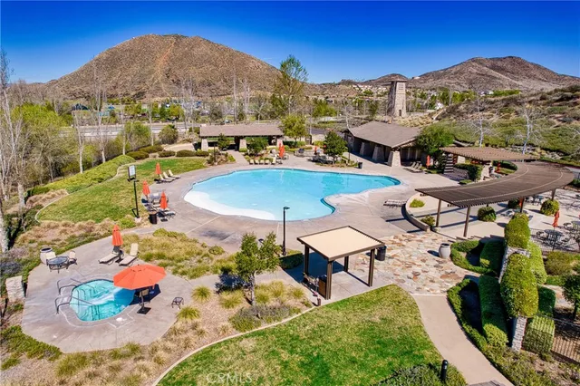 a view of a patio with chairs and table under an umbrella