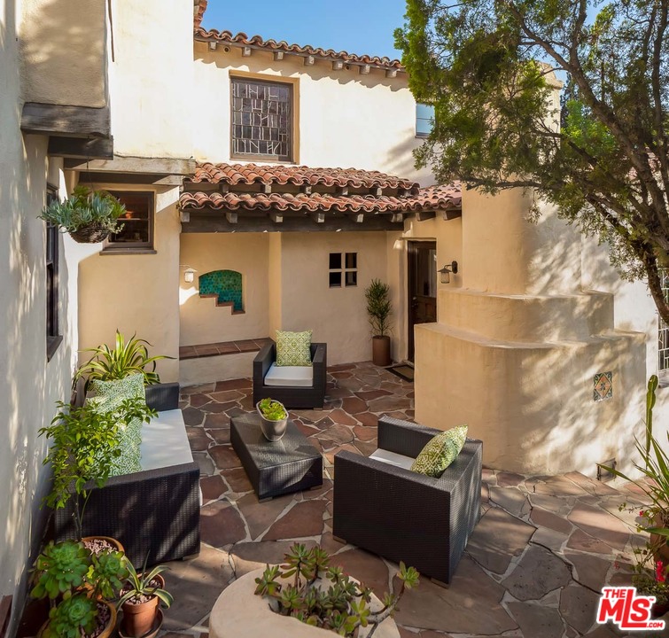 4342 Cedarhurst Circle Los Angeles, CA 90027 - Photo 35 of 44 a view of a patio with couches table and chairs potted plants and a large tree