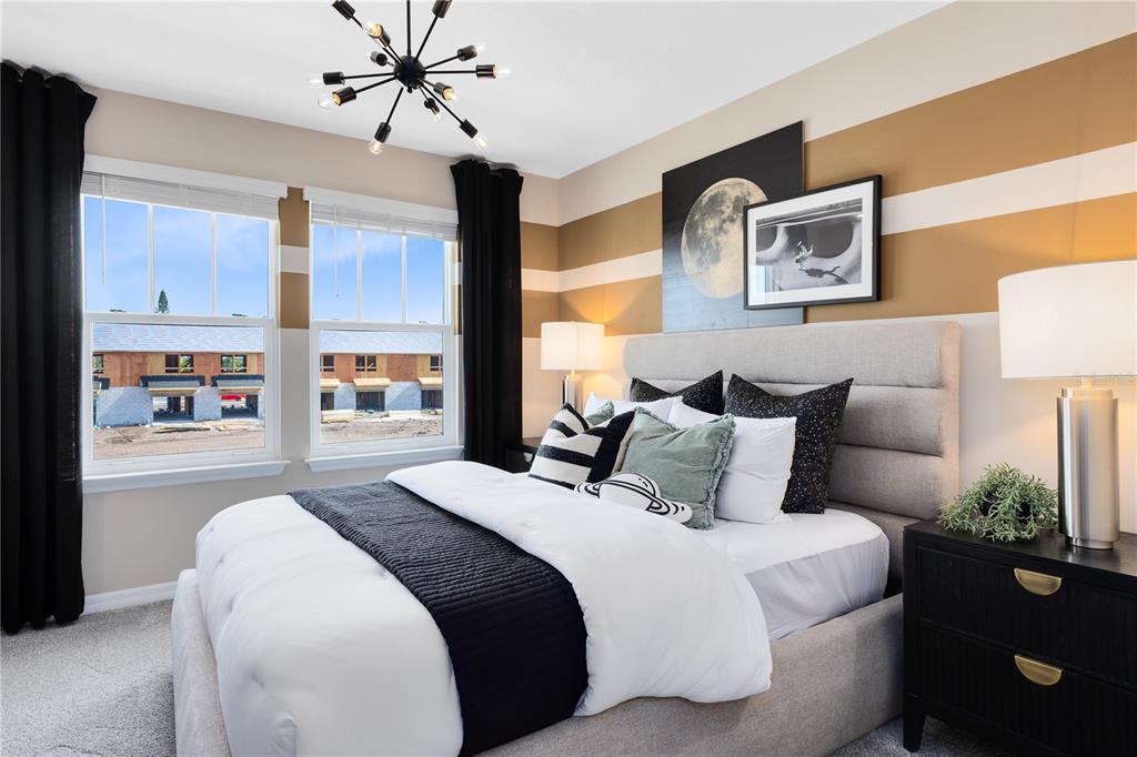 4315 Jetty Lane Palm Bay, FL 32905 - Photo 25 of 32 a bedroom with bed and a chandelier