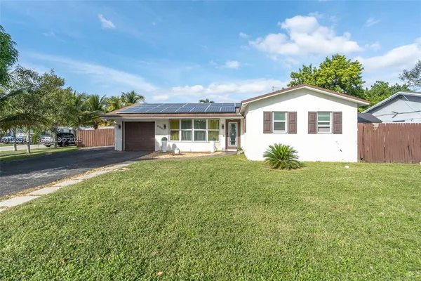 a front view of house with yard and green space