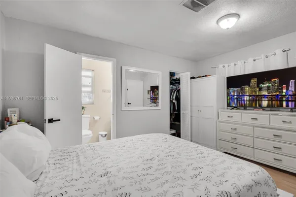 a bedroom with a bed and a mirror