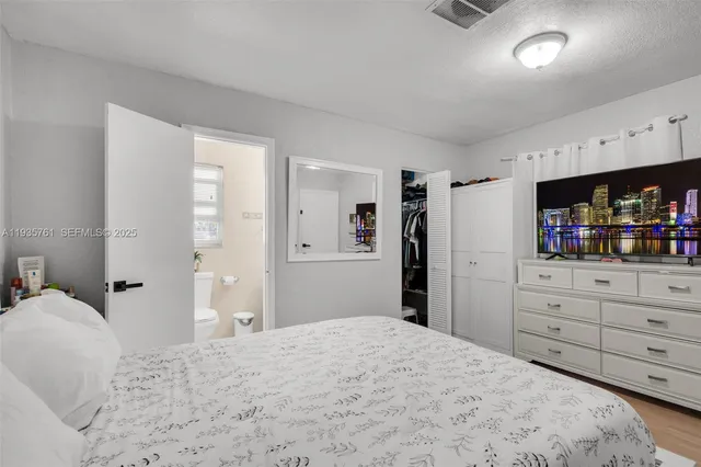 a bedroom with a bed and a mirror