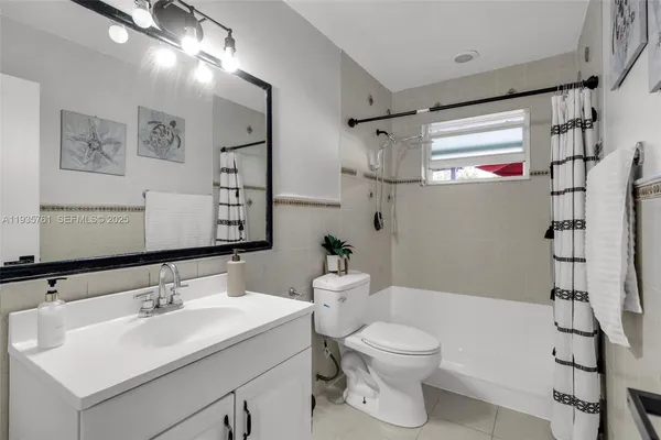 a bathroom with a sink toilet tub and shower