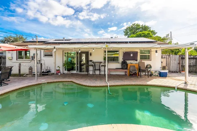 a view of a house with furniture and a backyard