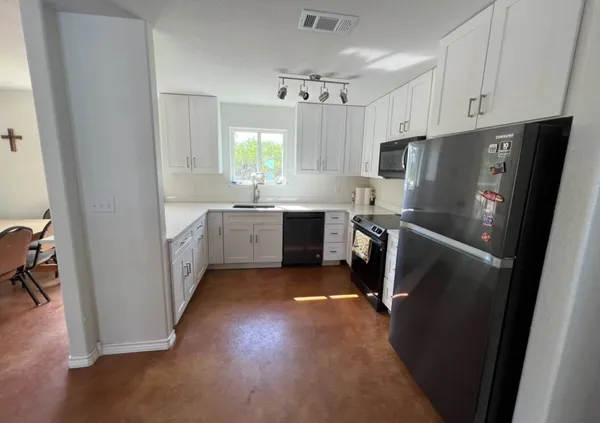 a kitchen with refrigerator and window