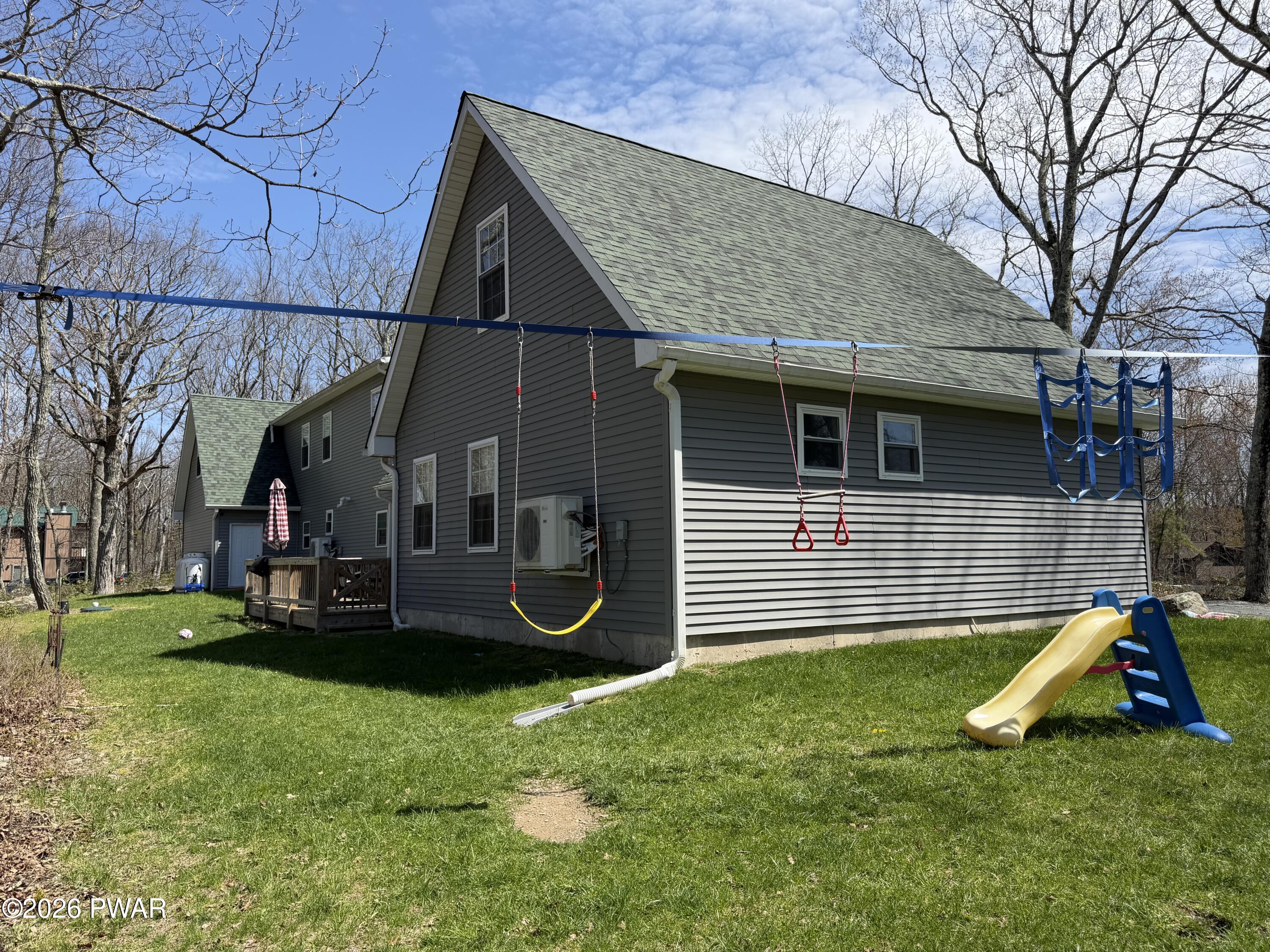 801 Maple Ridge Court Hawley, PA 18428 - Photo 4 of 55 a view of a house with a yard and a bench
