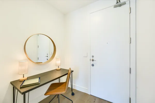 a kitchen with stainless steel appliances granite countertop a stove top oven a sink dishwasher and white cabinets with wooden floor
