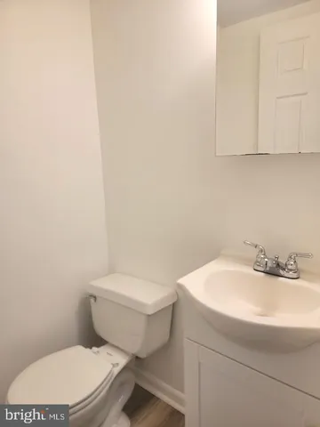 a white toilet sitting next to a white sink