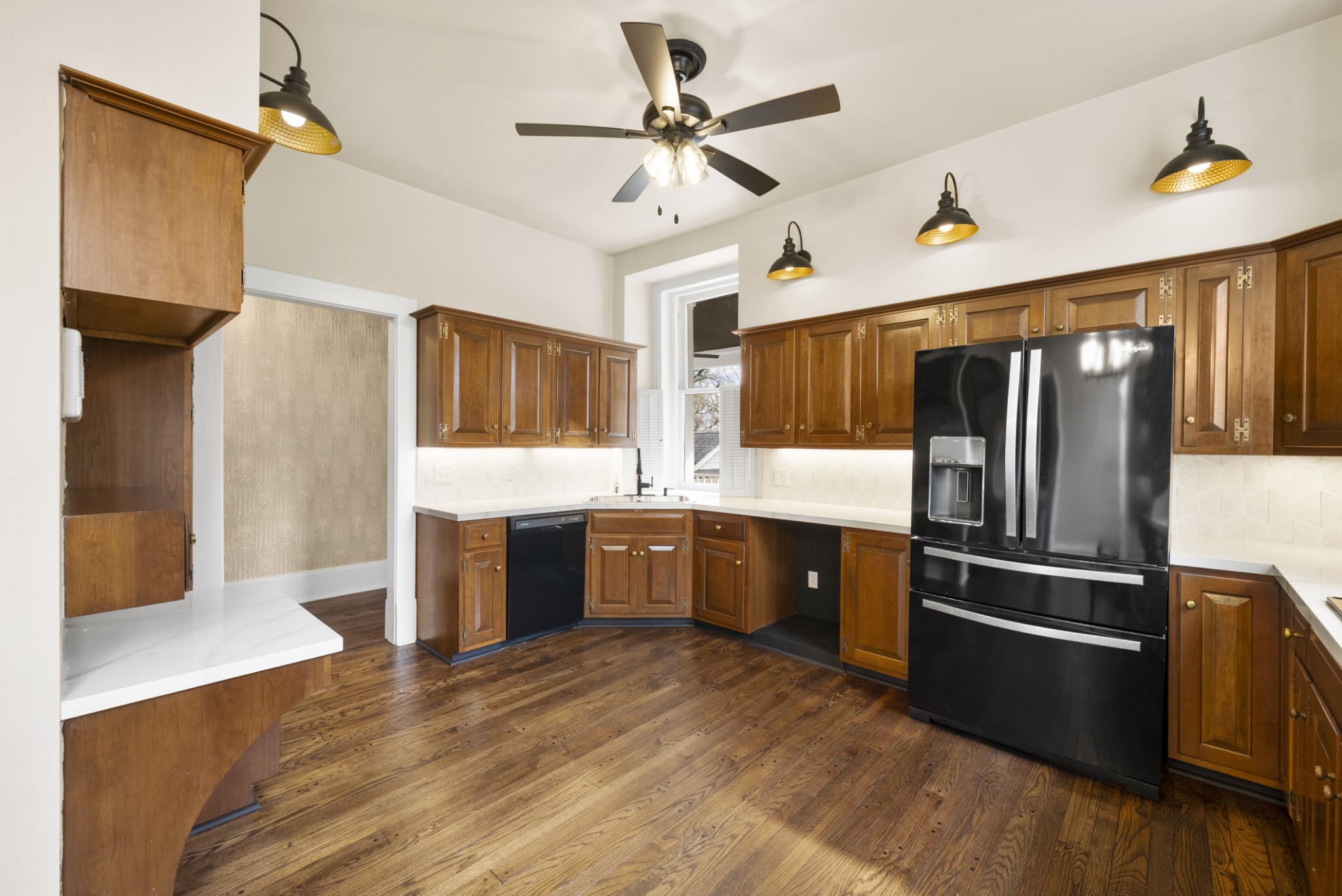 343 Forrest Street Lewisburg, TN 37091 - Photo 15 of 84 a kitchen with stainless steel appliances kitchen island granite countertop a refrigerator a sink dishwasher a stove and a dining table with wooden floor