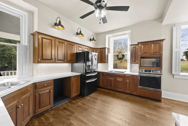 a view of an empty room with window and fireplace