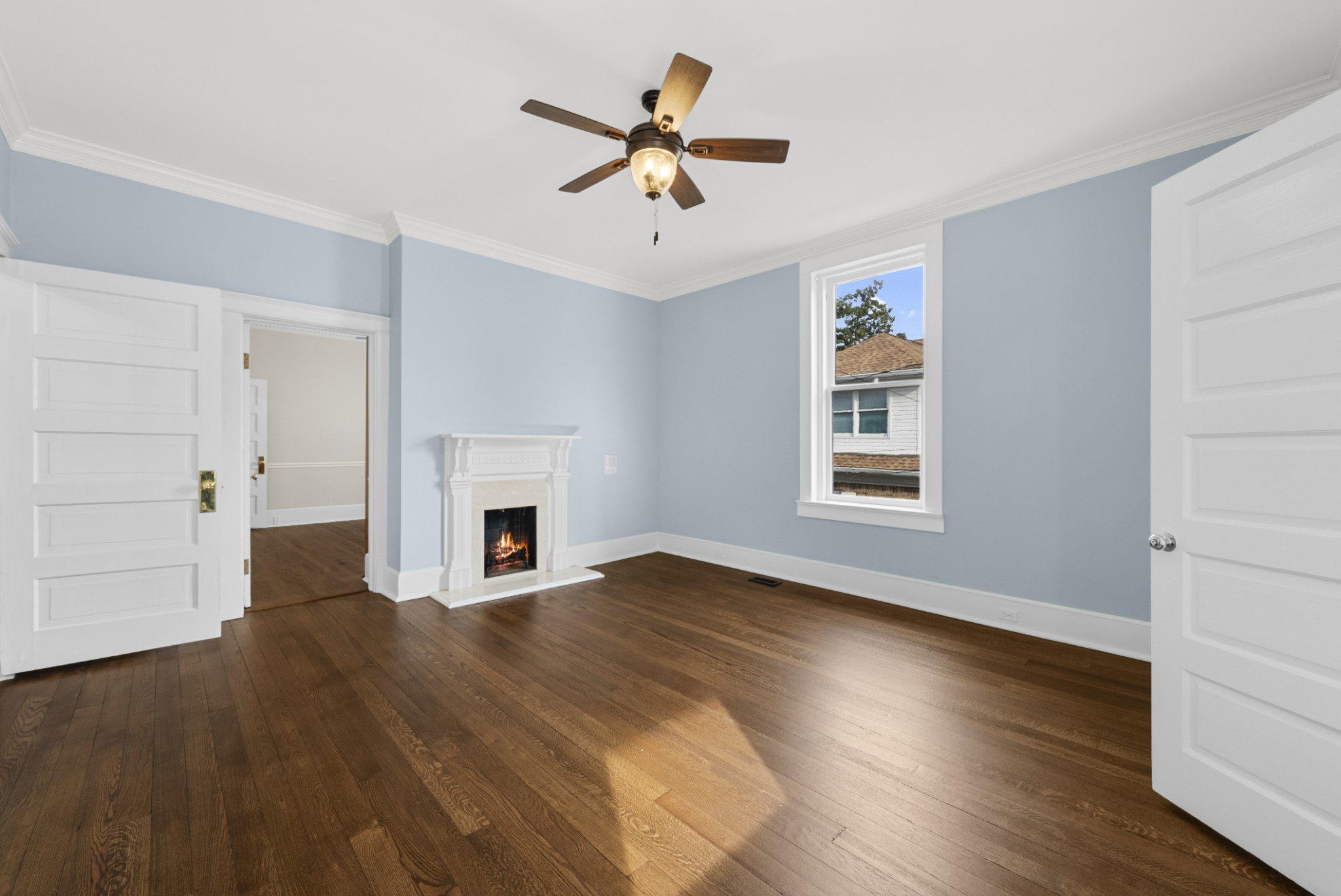 343 Forrest Street Lewisburg, TN 37091 - Photo 23 of 84 an empty room with windows a fireplace a ceiling fan and wooden floor