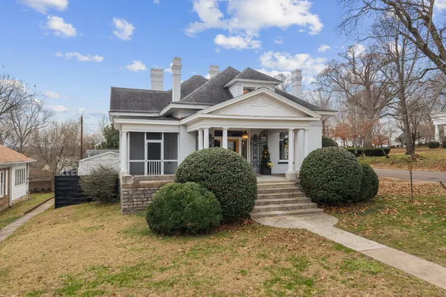 a view of a livingroom with wooden floor and a fireplace