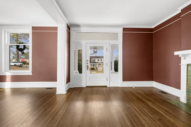 a view of livingroom with window fireplace and wooden floor