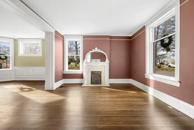 a view of staircase with lots of frames and wooden floor