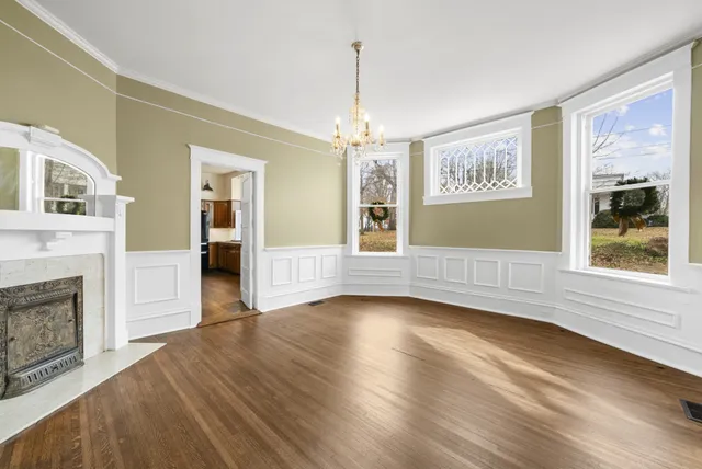 a kitchen with stainless steel appliances kitchen island granite countertop a refrigerator a sink dishwasher a stove and a dining table with wooden floor