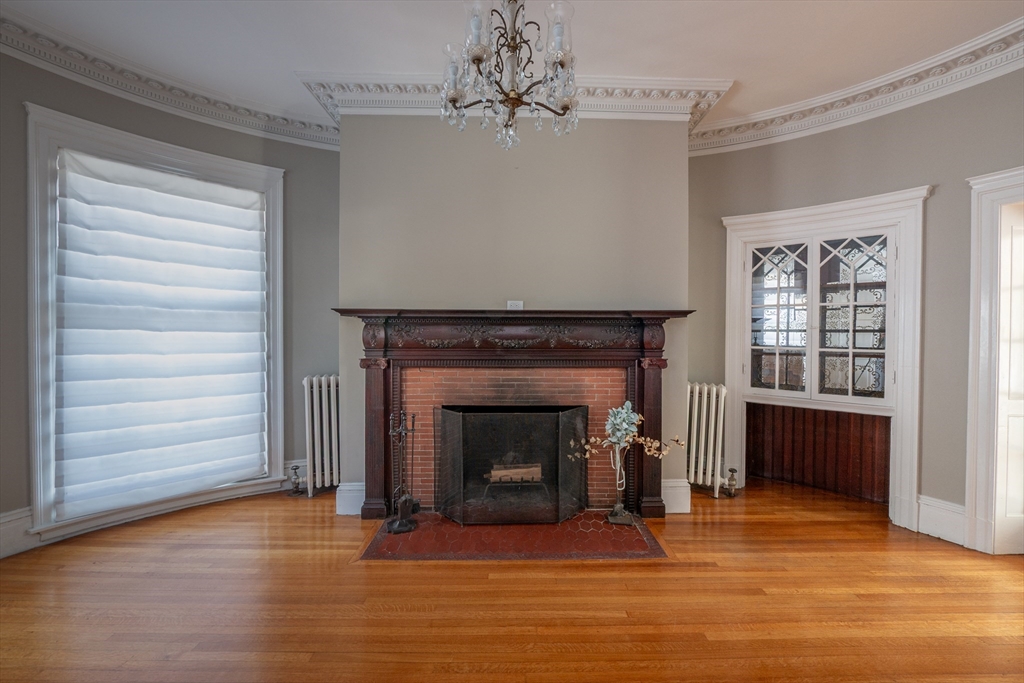 11 Wayne Street Boston, MA 02121 - Photo 5 of 27 a living room with a fireplace