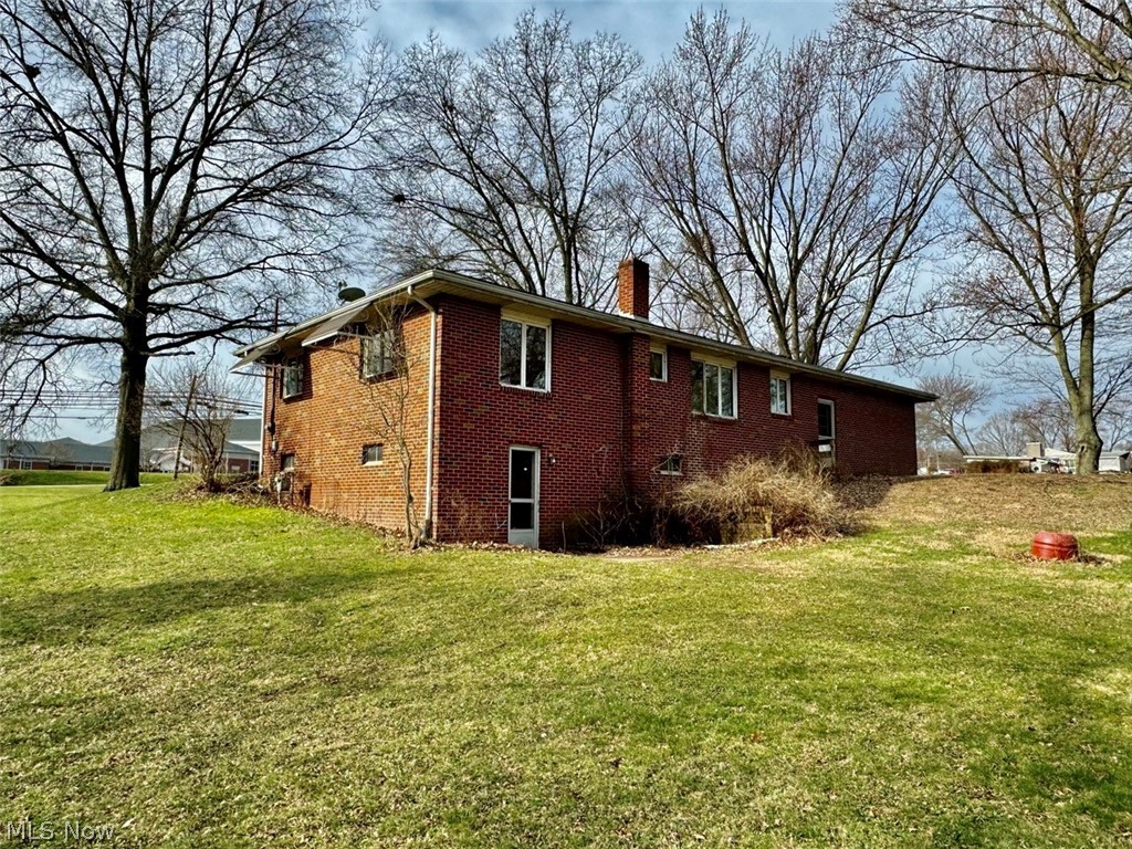 1445 Killian Road Akron, OH 44312 - Photo 2 of 21 Back view of property featuring a yard