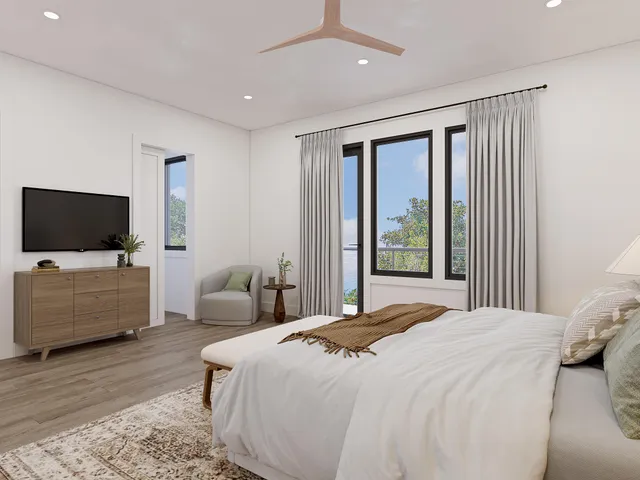 a bedroom with a flat screen tv and a bed