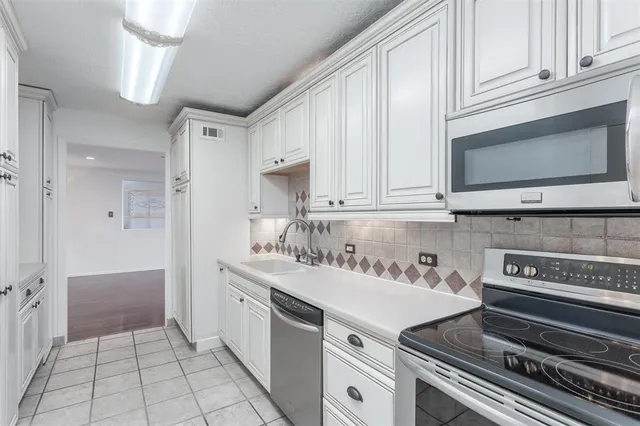 a kitchen with a sink cabinets and window