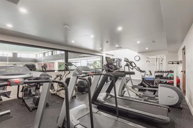 a room with pool table and windows