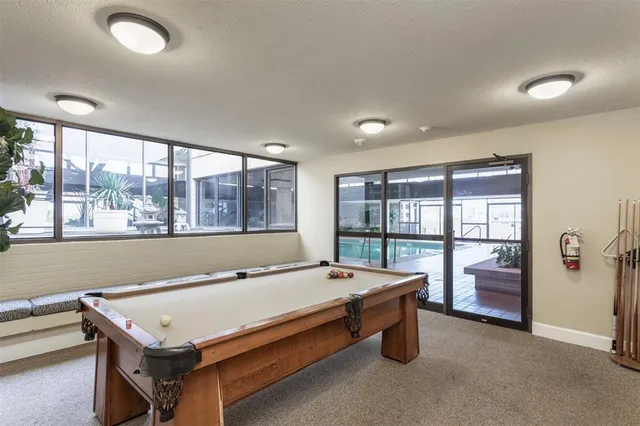 a living room with furniture a chandelier and a large window