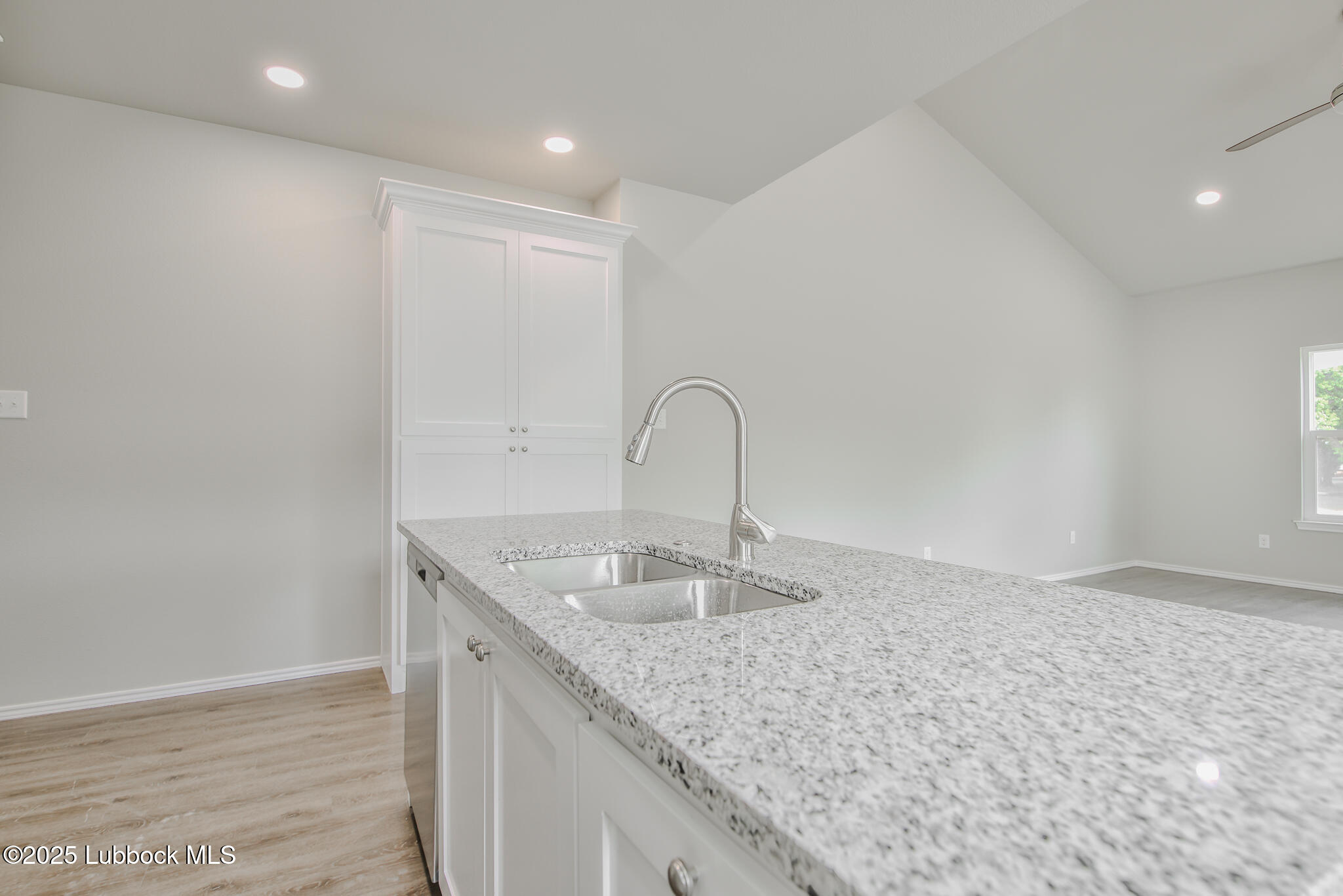 3117 74th Street Lubbock, TX 79423 - Photo 16 of 36 a kitchen with granite countertop a sink and a granite counter tops