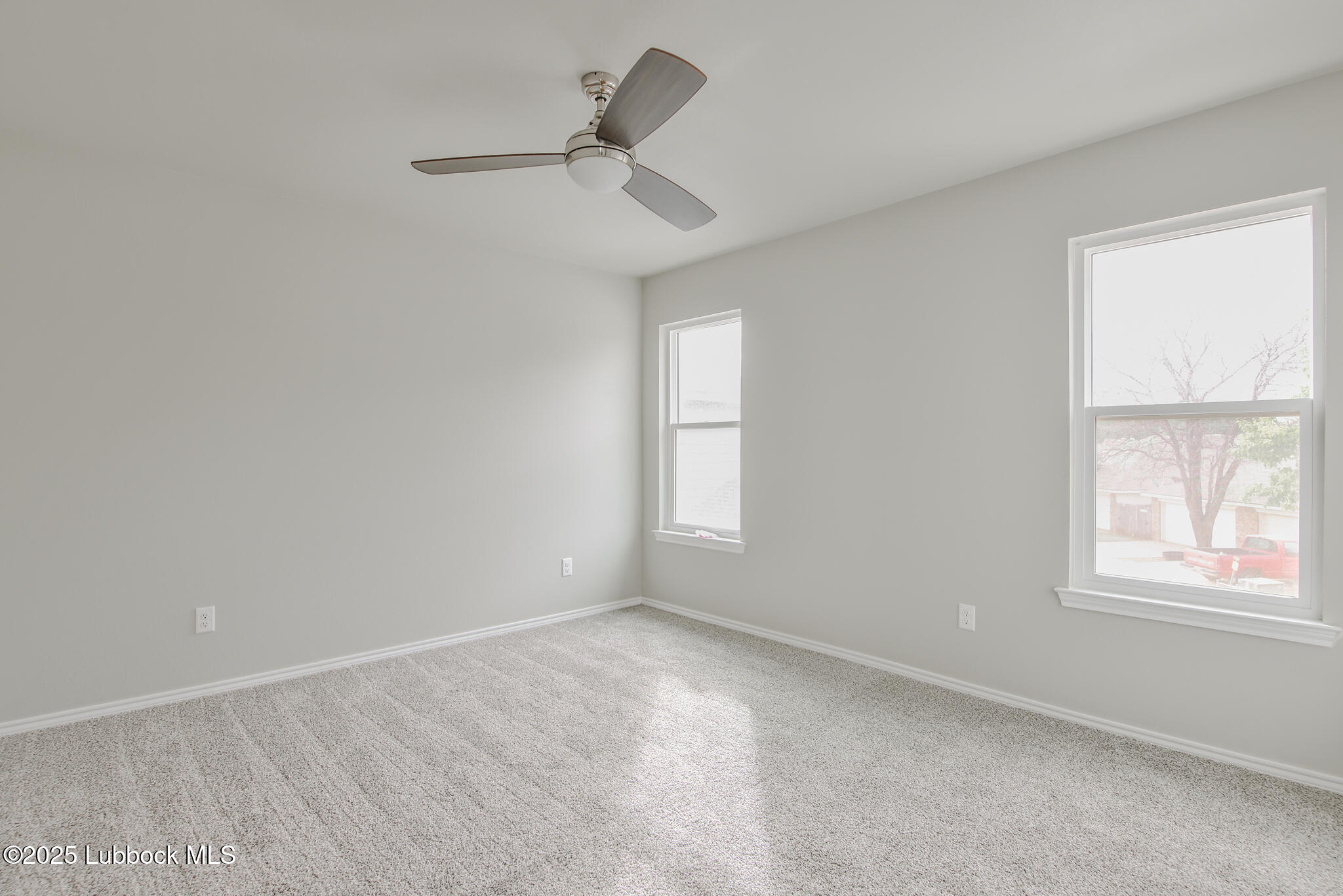 3117 74th Street Lubbock, TX 79423 - Photo 33 of 36 an empty room with a window and ceiling fan