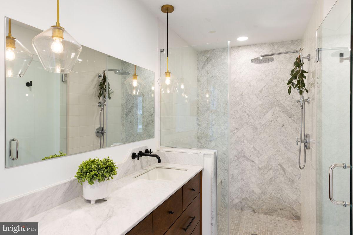1401 Carol Road Jenkintown, PA 19046 - Photo 16 of 30 a bathroom with a sink mirror and a shower