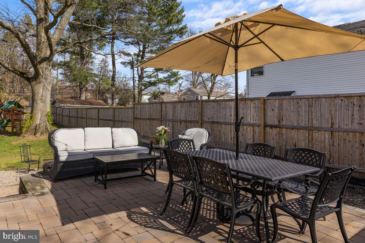 1401 Carol Road Jenkintown, PA 19046 - Photo 26 of 30 a view of a roof deck with table and chairs under an umbrella