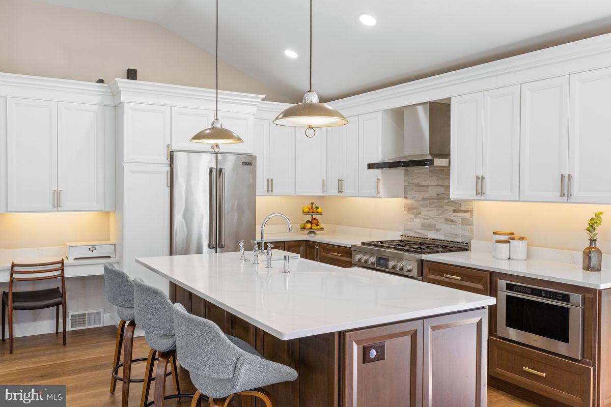 1401 Carol Road Jenkintown, PA 19046 - Photo 5 of 30 a kitchen with a stove a refrigerator and a dining table