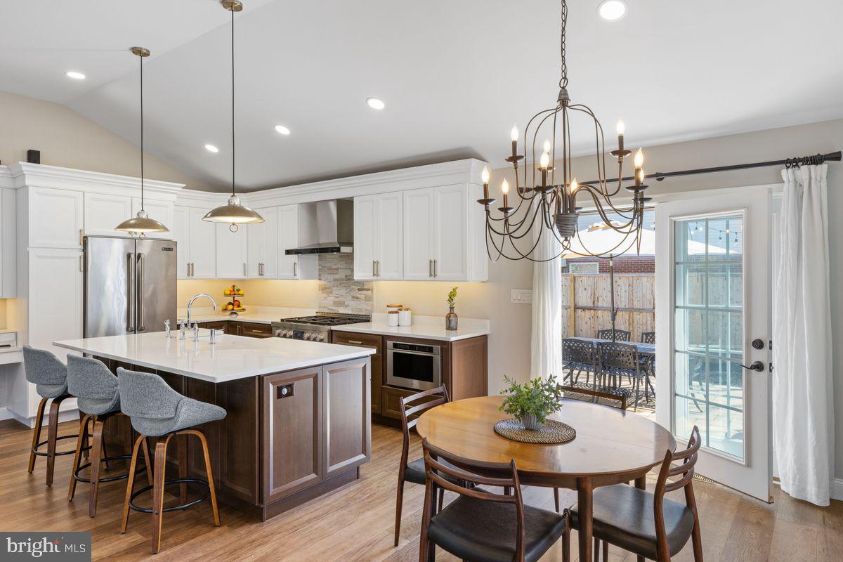 1401 Carol Road Jenkintown, PA 19046 - Photo 9 of 30 a kitchen with stainless steel appliances a dining table chairs and wooden floor
