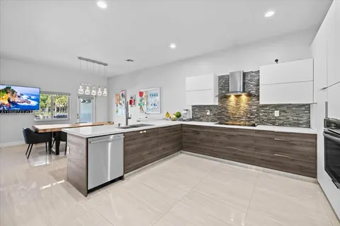 a kitchen with stainless steel appliances kitchen island granite countertop a sink and cabinets