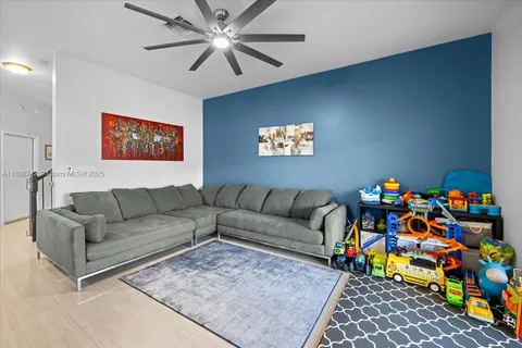 a living room with a couch and a bookshelf