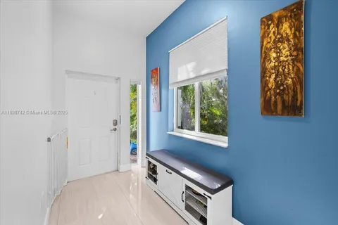 a view of hallway with windows and a fireplace