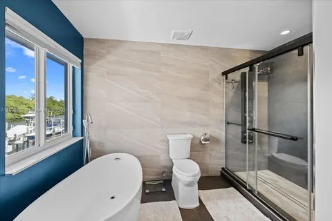 a bathroom with a toilet and a shower