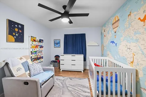 a bedroom with furniture and a baby crib