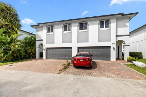 a car parked in front of white house