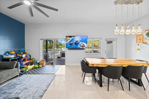 a dining room with furniture and a chandelier