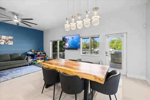 a view of a dining room with furniture and a chandelier