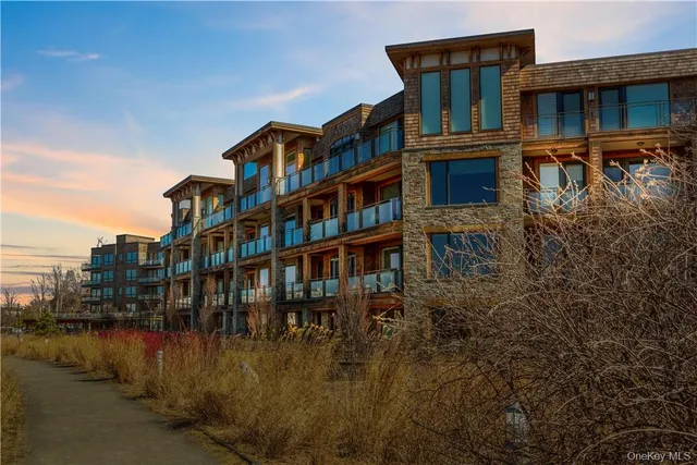 a view of a brick building next to a lake