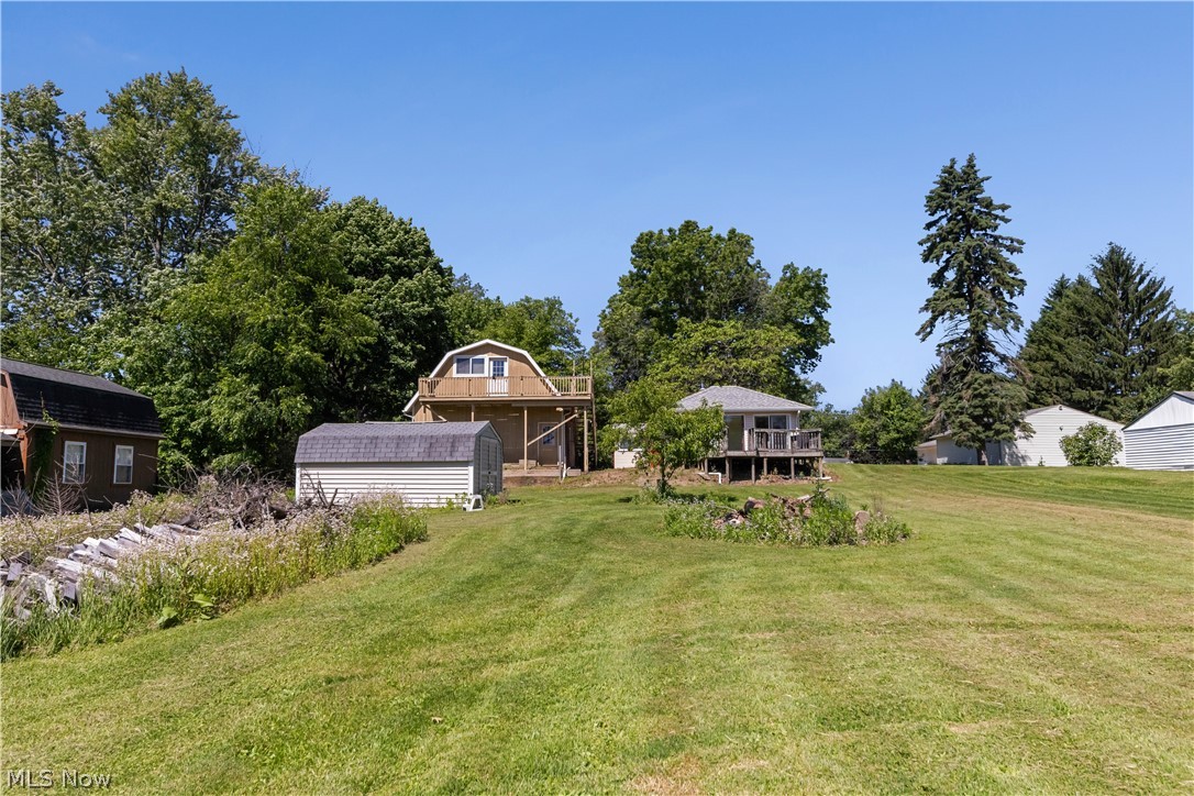 409 Edith Avenue Akron, OH 44312 - Photo 33 of 45 Expansive green lawn with a detached shed and multiple mature trees