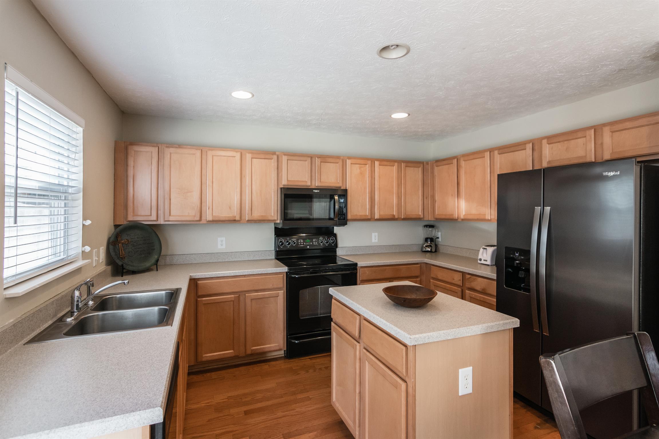 3909 Stephens Ridge Way Antioch, TN 37013 - Photo 8 of 25 a kitchen with a stove a refrigerator and a sink